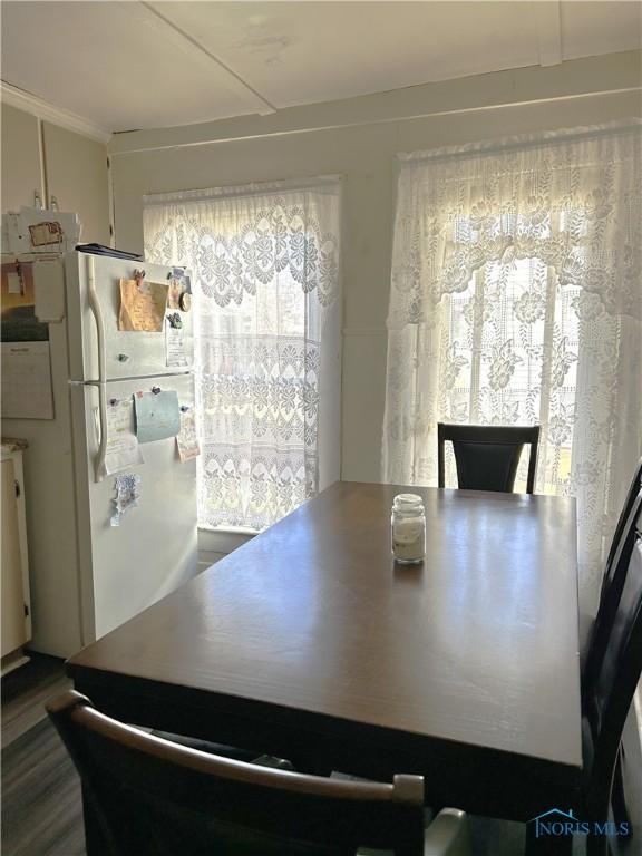 dining area with dark wood-style flooring