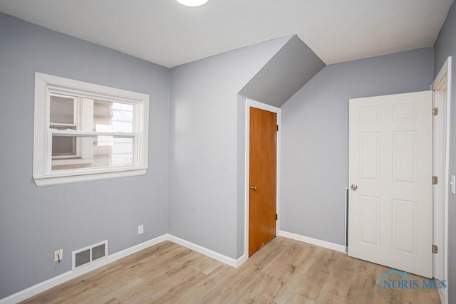 interior space with visible vents, baseboards, and wood finished floors