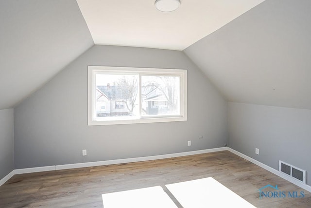 bonus room with visible vents, baseboards, and wood finished floors