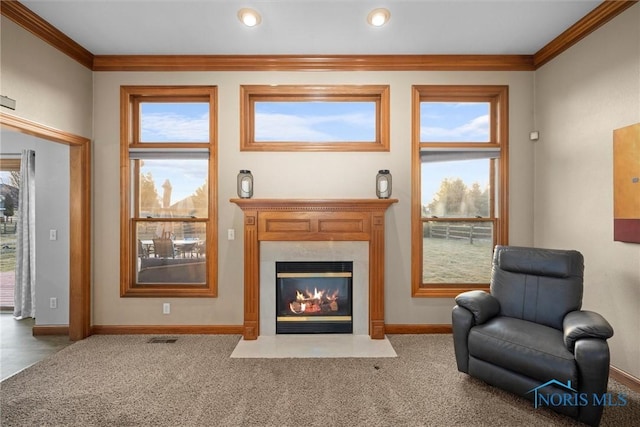sitting room featuring crown molding, a high end fireplace, carpet flooring, and visible vents