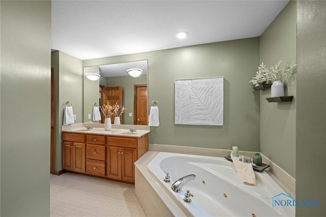 bathroom featuring a sink, a jetted tub, and double vanity