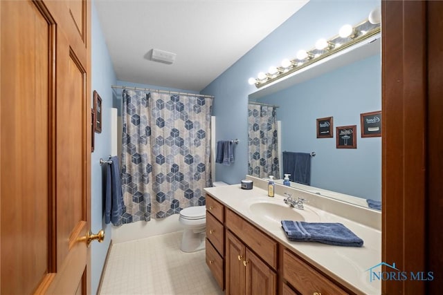 bathroom with toilet, tile patterned floors, and vanity