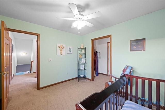 bedroom featuring baseboards, light carpet, and a ceiling fan