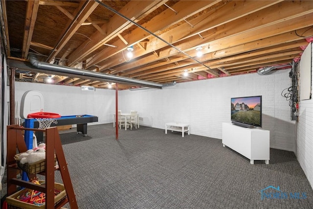 basement with pool table, carpet, and brick wall