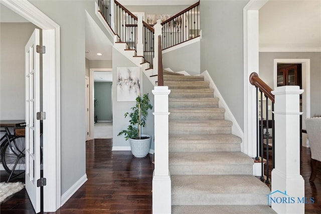 stairway featuring wood finished floors and baseboards