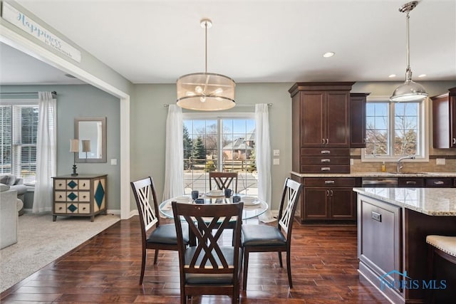 dining room with recessed lighting, baseboards, a notable chandelier, and dark wood-style floors