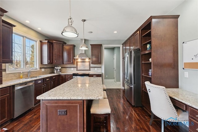 kitchen with tasteful backsplash, a sink, a center island, appliances with stainless steel finishes, and open shelves