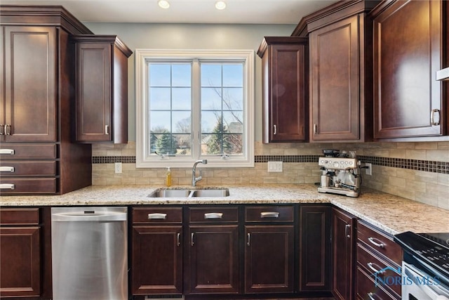 kitchen featuring a sink, light stone counters, tasteful backsplash, and stainless steel appliances