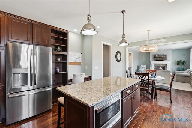 kitchen featuring dark wood finished floors, appliances with stainless steel finishes, pendant lighting, and open shelves