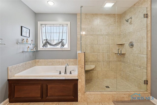 bathroom featuring a shower stall and a garden tub