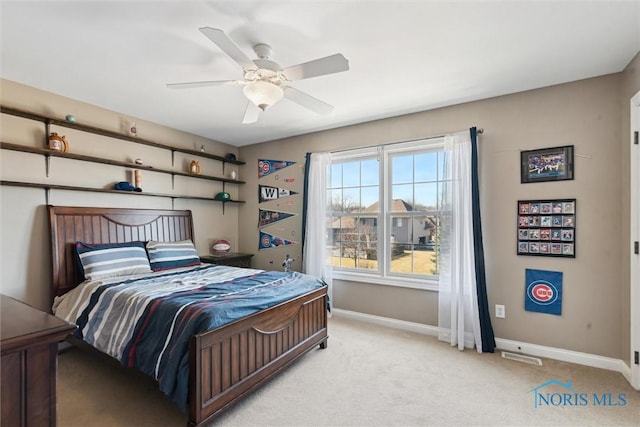 bedroom featuring ceiling fan, baseboards, and light carpet