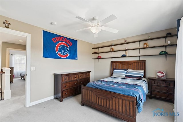 carpeted bedroom with baseboards and ceiling fan