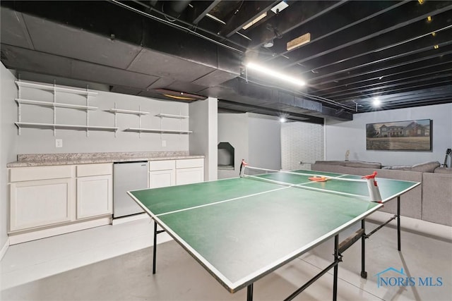 game room with concrete flooring and indoor bar