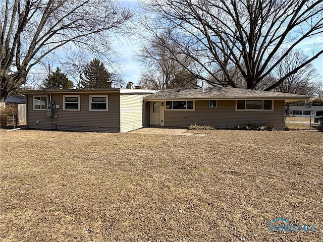 rear view of property with fence