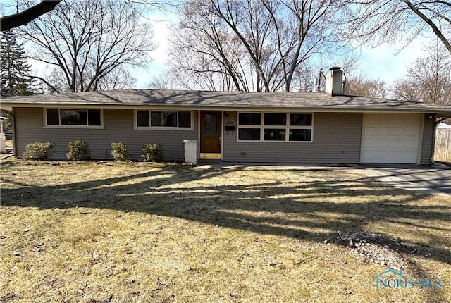 ranch-style home with a front yard, an attached garage, driveway, and a chimney