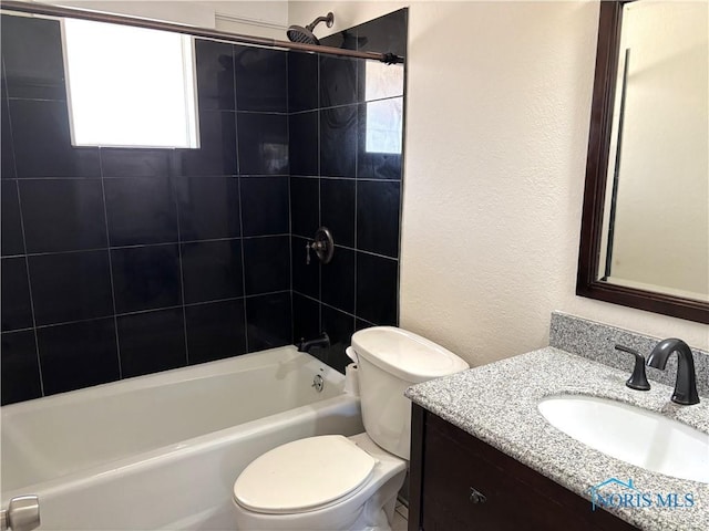 full bathroom featuring a textured wall, vanity, shower / bathtub combination, and toilet