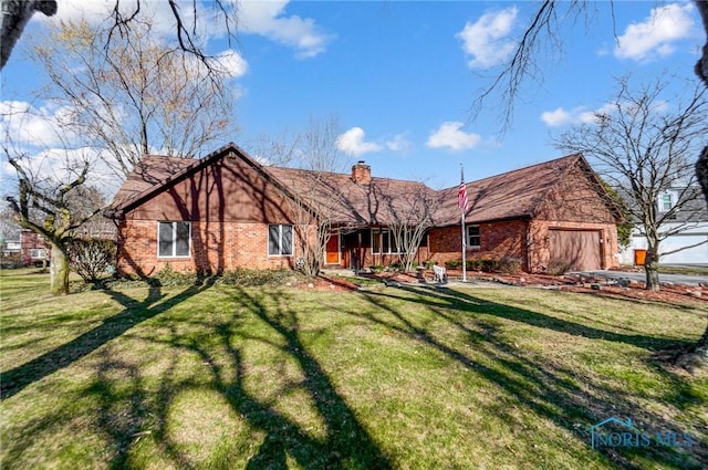 view of front facade featuring brick siding, an attached garage, a chimney, and a front yard