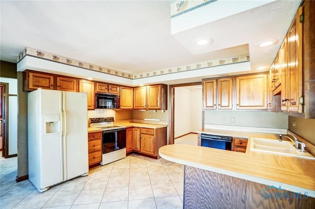 kitchen featuring light tile patterned floors, white appliances, light countertops, and a sink