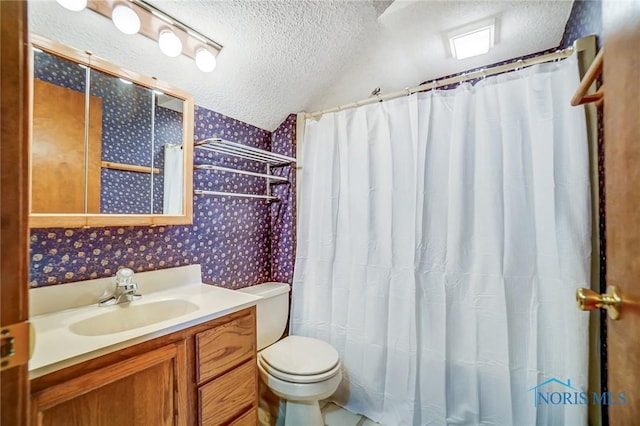 bathroom featuring toilet, a textured ceiling, wallpapered walls, lofted ceiling, and vanity