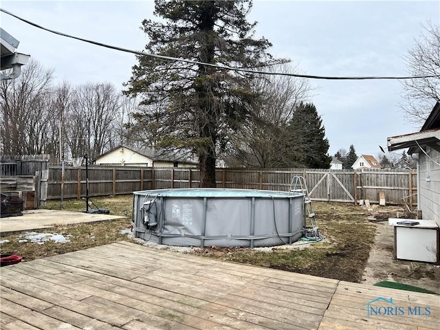 wooden terrace featuring a fenced in pool and a fenced backyard