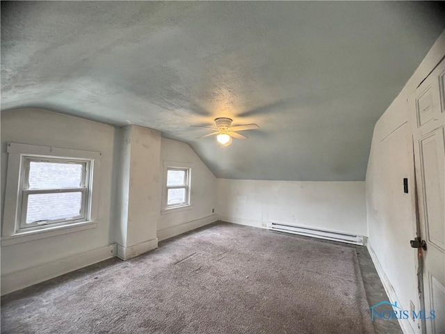 bonus room with a ceiling fan, carpet floors, lofted ceiling, a textured ceiling, and a baseboard heating unit