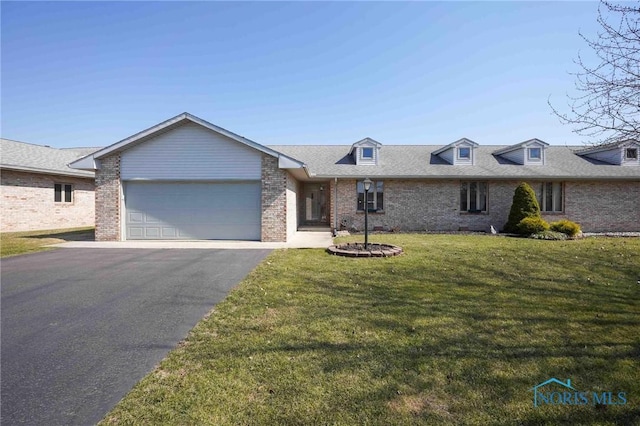 ranch-style house featuring roof with shingles, a front lawn, a garage, aphalt driveway, and brick siding