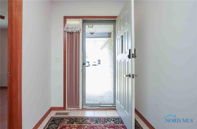 entrance foyer featuring light tile patterned floors, baseboards, and visible vents