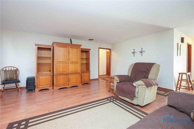 living area featuring light wood-type flooring and baseboards