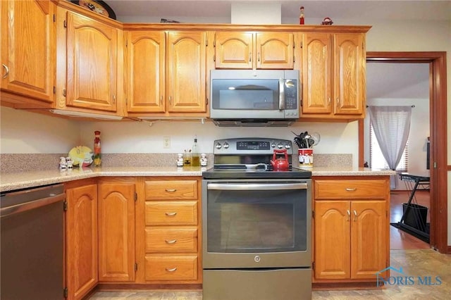 kitchen with appliances with stainless steel finishes and light countertops