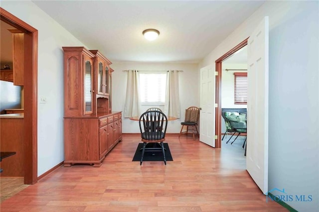 dining room with light wood-type flooring and baseboards