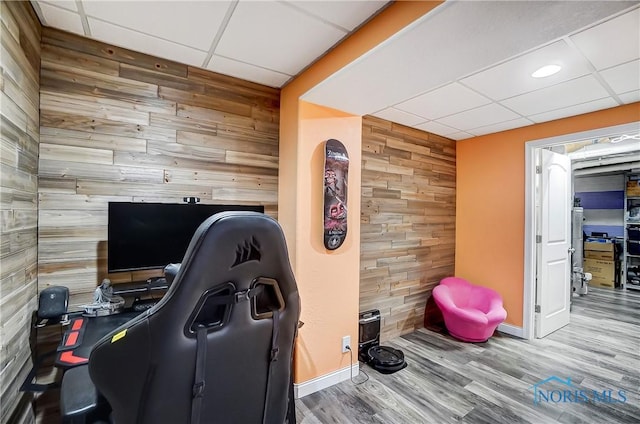 7221 Apache Trl, Holland, OH 43528 - office space with wooden walls, a drop ceiling, an accent wall, baseboards, and wood finished floors