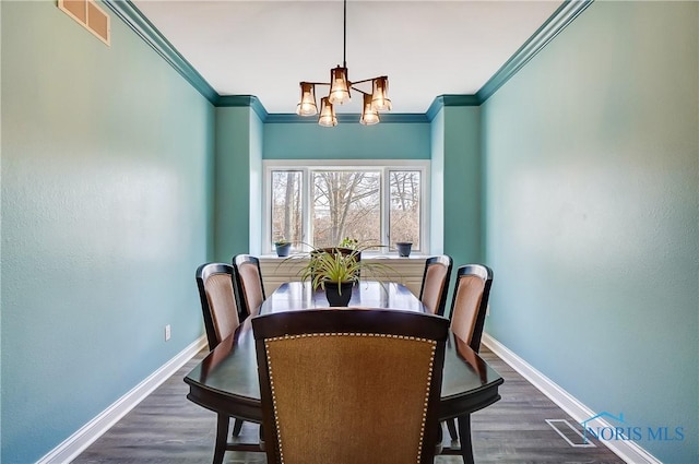 7221 Apache Trl, Holland, OH 43528 - dining room with a chandelier, baseboards, crown molding, and dark wood-style floors