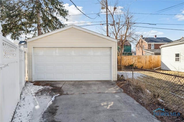 detached garage featuring fence