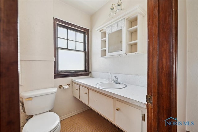 bathroom with toilet and vanity