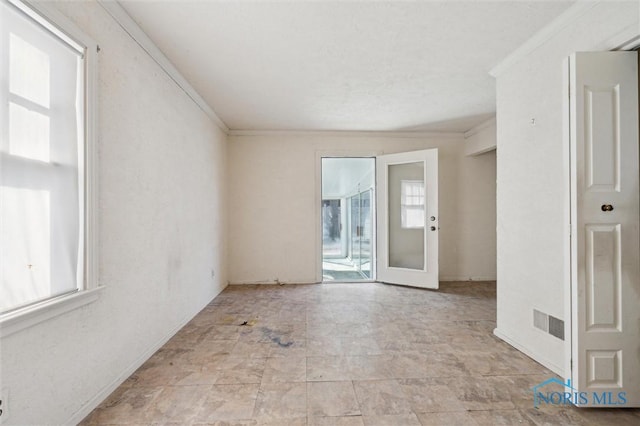 unfurnished room featuring visible vents and ornamental molding