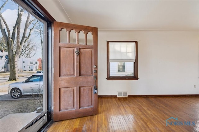 entrance foyer with visible vents, light wood-type flooring, and baseboards