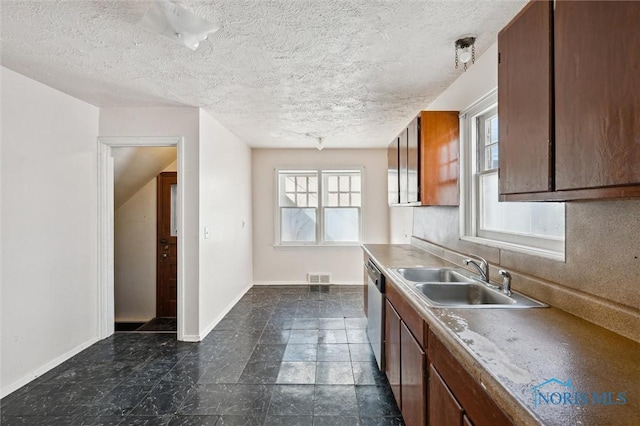 kitchen featuring visible vents, a sink, a textured ceiling, baseboards, and dishwasher