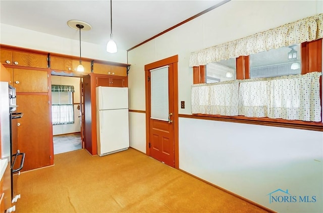 kitchen with pendant lighting, freestanding refrigerator, and carpet floors