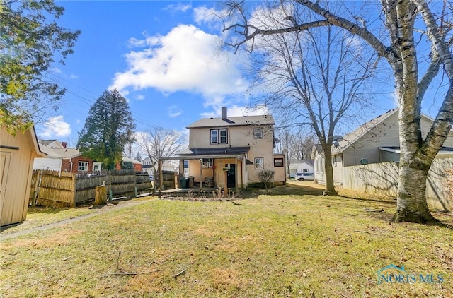 back of house featuring a patio area, a yard, and fence