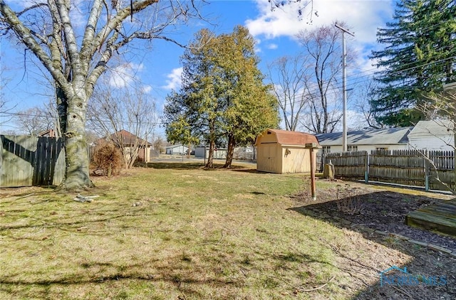 view of yard featuring a fenced backyard, a shed, and an outdoor structure