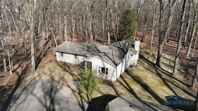 drone / aerial view featuring a view of trees