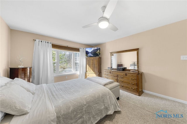 carpeted bedroom with a ceiling fan and baseboards