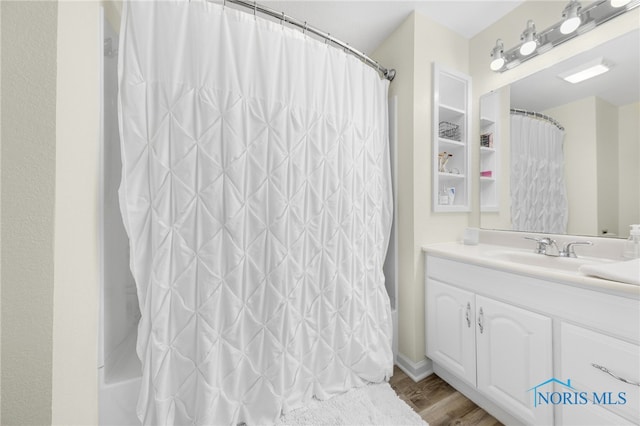 full bath with vanity, shower / bath combo, and wood finished floors