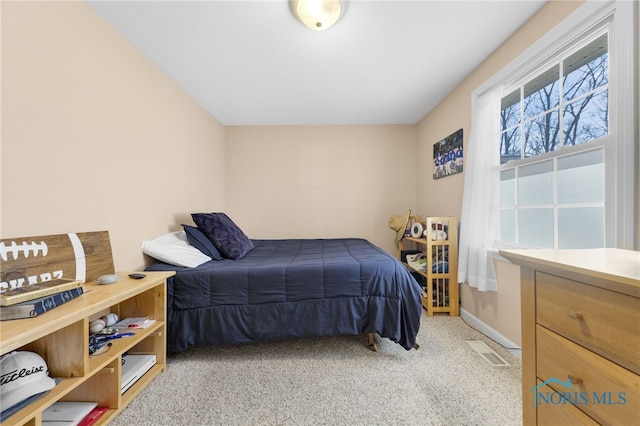 carpeted bedroom featuring visible vents and baseboards