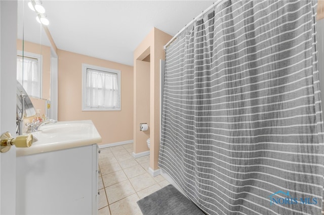 full bathroom featuring tile patterned floors, baseboards, toilet, and vanity