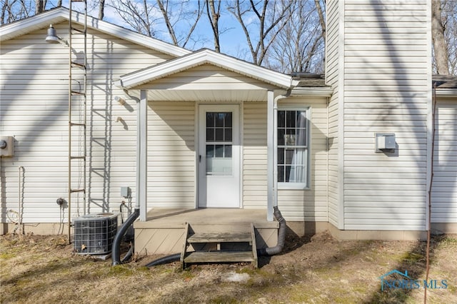 rear view of property featuring cooling unit and a deck