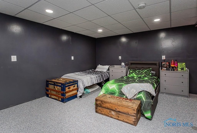 carpeted bedroom with recessed lighting and a paneled ceiling