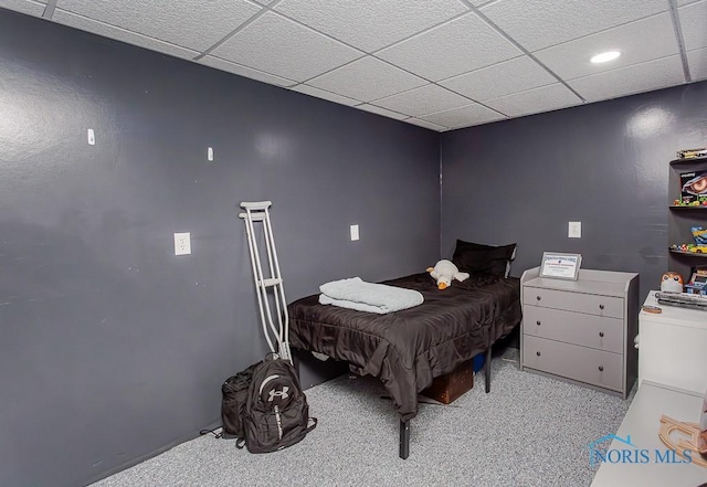 carpeted bedroom with a drop ceiling