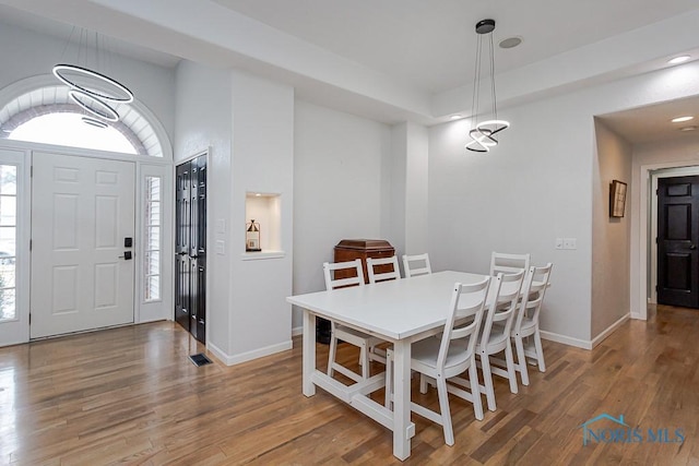 dining space featuring recessed lighting, baseboards, and wood finished floors