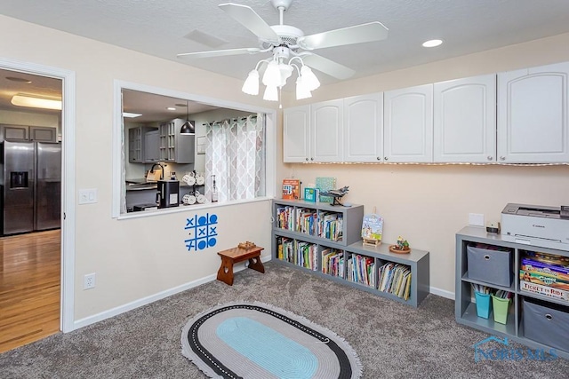 game room with carpet flooring, a ceiling fan, baseboards, and a sink